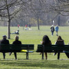 People sit on park benches, as they enjoy the sunny weather at the English Garden in downtown Munich April 8, 2010.  REUTERS/Michaela Rehle (GERMANY - Tags: ENVIRONMENT SOCIETY) - RTR2CK9W