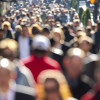 Anonymous crowd of people walking street