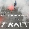 (FILES) In this file photo taken on June 9, 2016 A trade union activist stands in the middle of smoke bombs as he takes part in a demonstration of pensioners against the government's planned labour law reforms in Bordeaux, southwestern France.  Retirement age, special schemes, employment of seniors, long careers and hardship... the pension reform is highly contested even before its presentation on January 10, 2023. (Photo by NICOLAS TUCAT / AFP)